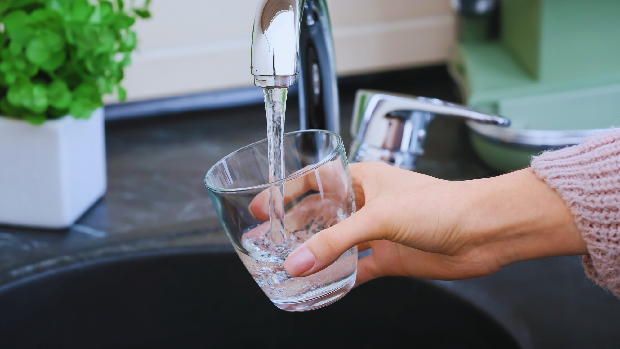 Whole-home water filtration system installed in Glassboro NJ by Krise Services, showing clean water flowing from a kitchen faucet.